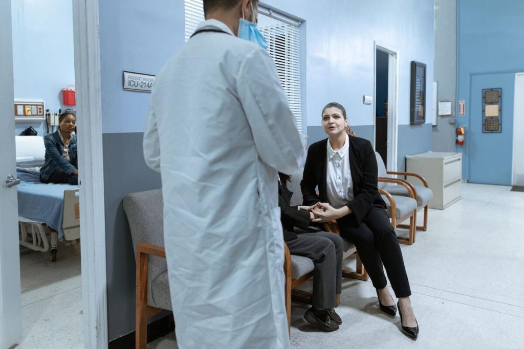 Doctor's office waiting room in autumn with coats and scarves, no people