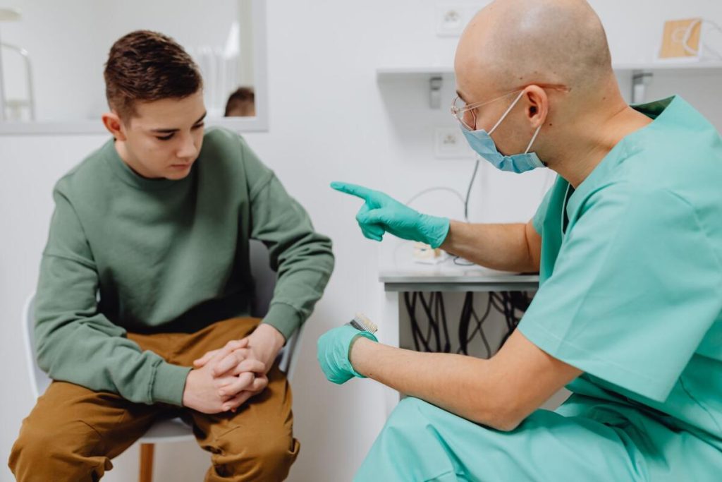 doctor consulting with teenage patient about nutrition, no visible faces, bright clinic room