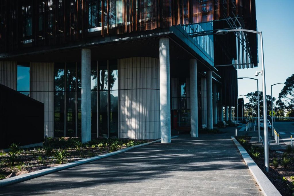 calm outdoor path near a modern healthcare facility, no people