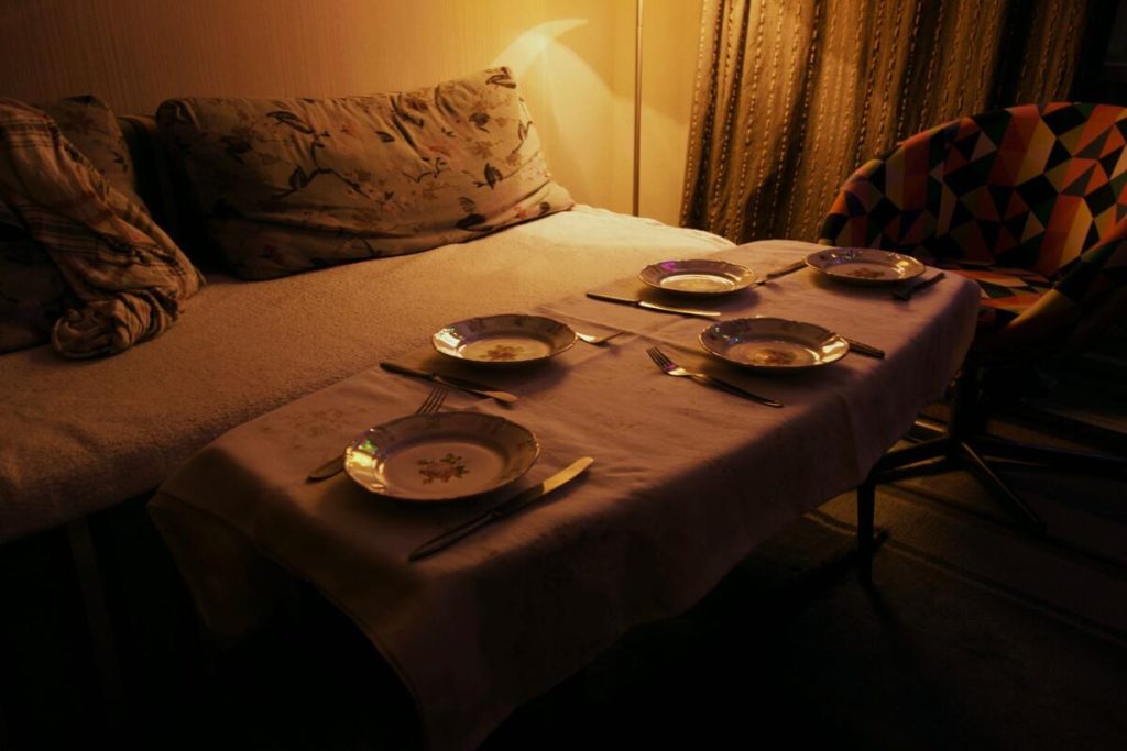 late night dinner plate on kitchen table, dim light, no people
