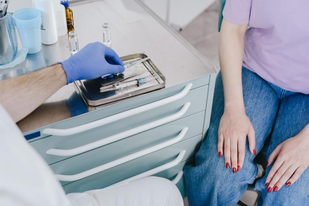 nurse preparing a seasonal flu vaccine syringe on a tray