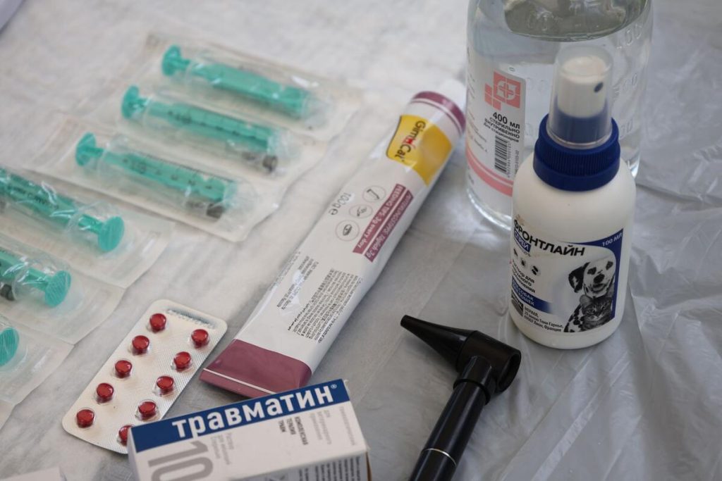 medical ostomy care paste tube and skin barrier supplies on a pharmacy counter, no people