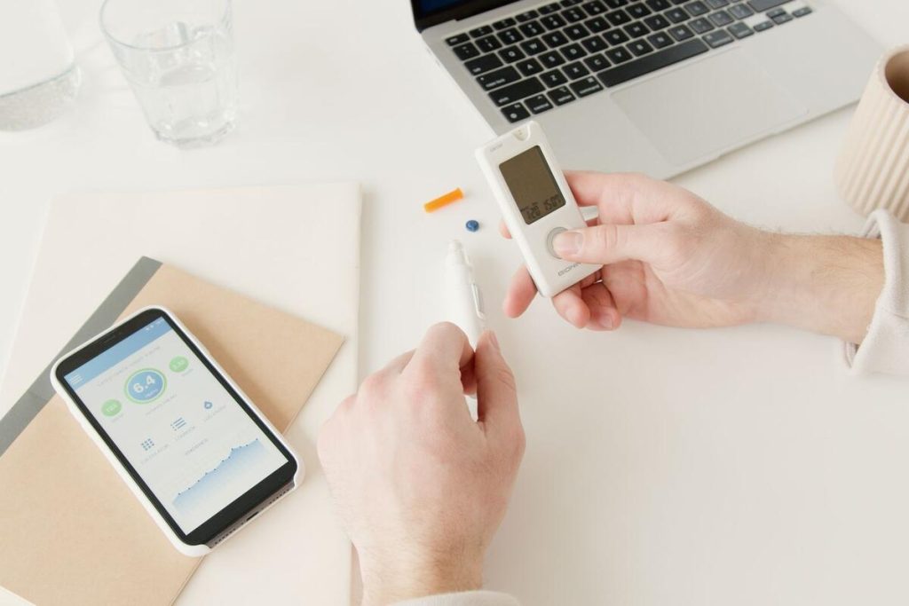doctor reviewing medical chart with glucose monitoring data, no faces visible