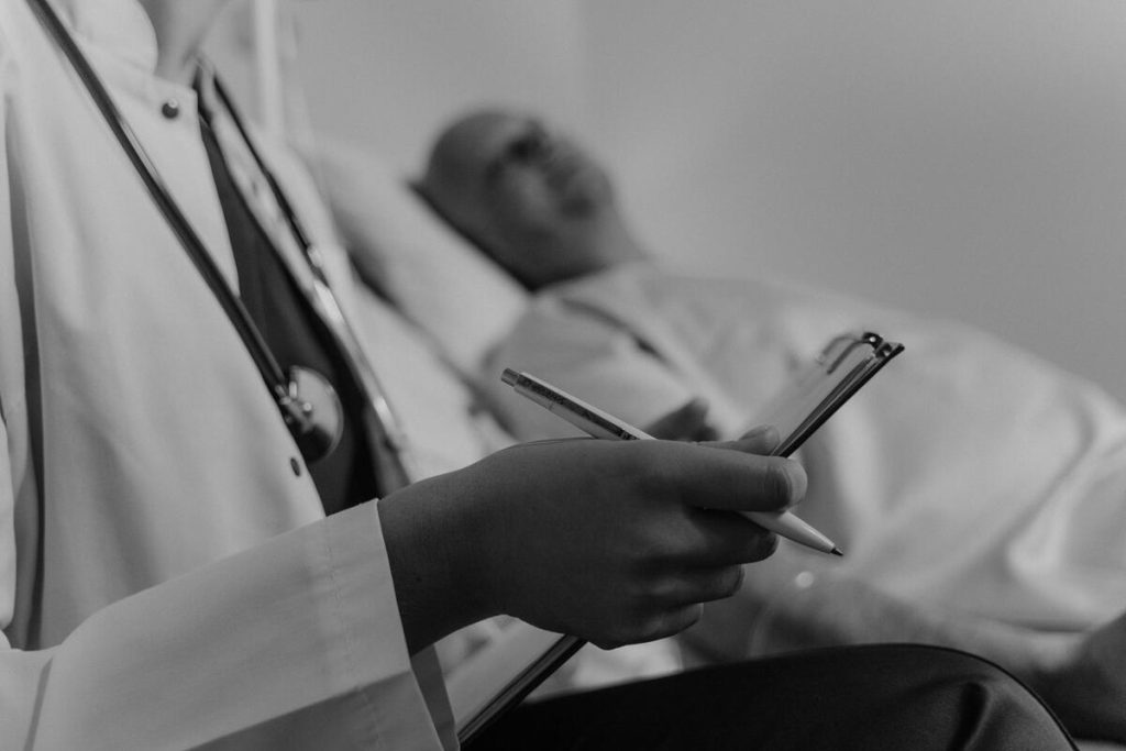 Oncologist discussing treatment plan with pancreatic cancer patient chart