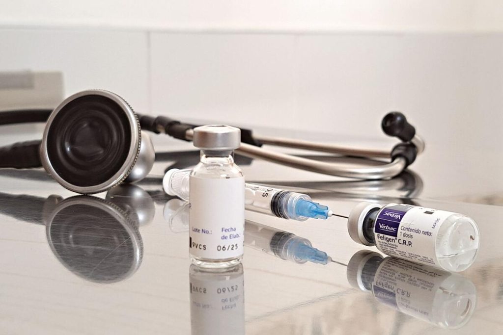 close-up of a medical injection pen and vial on a clean clinical table, no people
