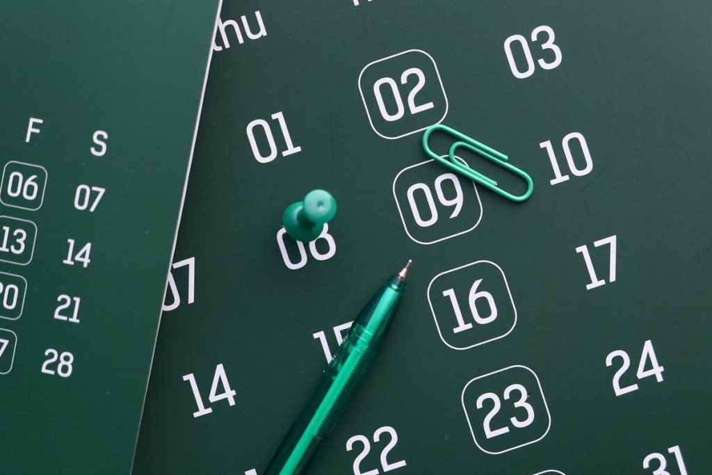 wall calendar with a pen marking dates, close-up, no people