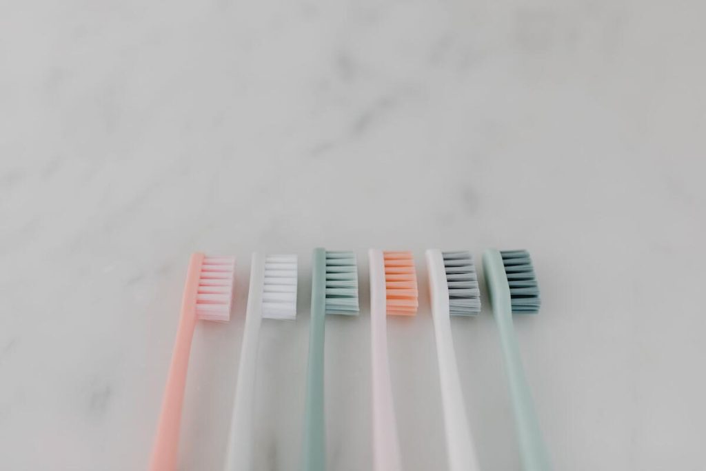 dental floss and toothbrush on a bathroom counter, no people