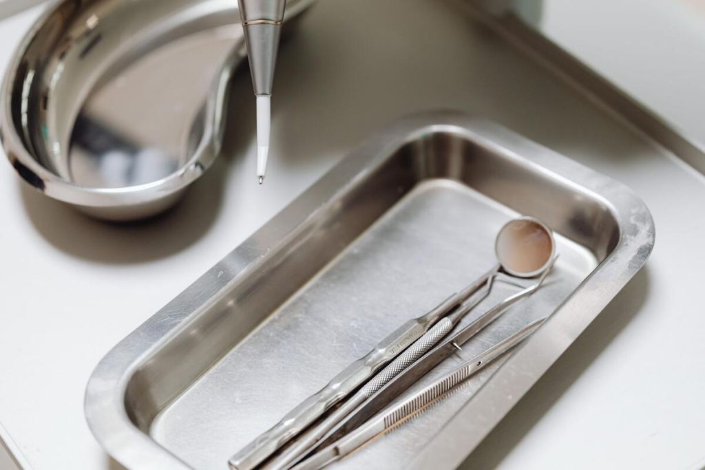dentist tools and mirror on a tray in a clean dental office, no people