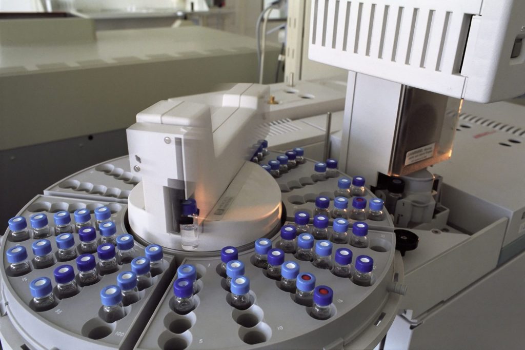 laboratory vials and medical research equipment, blue tone, no people
