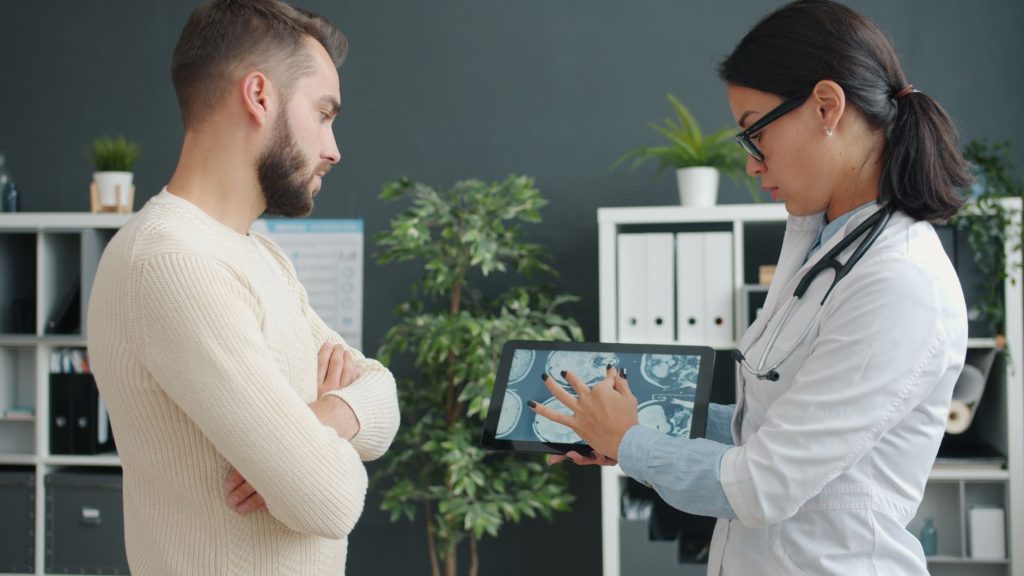 doctor reviewing liver test results on a tablet in a clinic, no faces visible