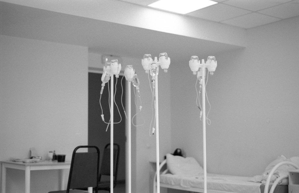 Close up of a hospital IV stand and medical equipment in a bright orthopedic ward, no people