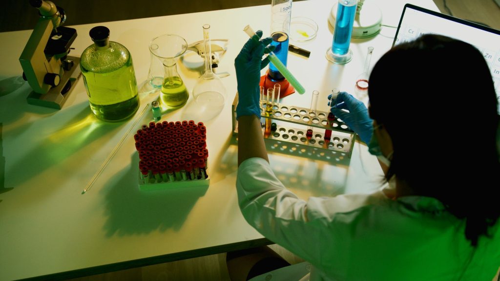 pharmaceutical research laboratory scientist analyzing vials, no faces