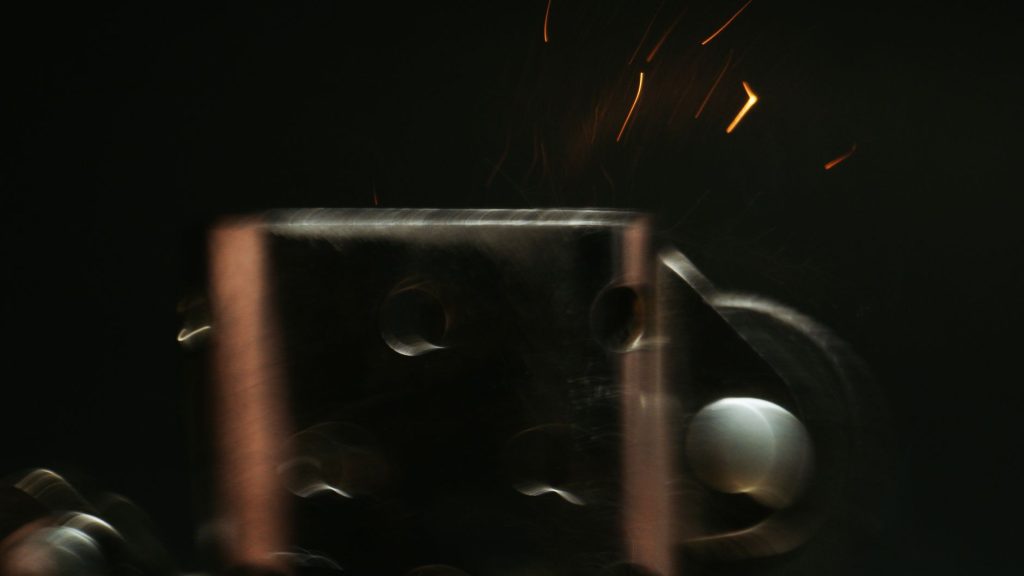 close-up photo of a heated tobacco stick device on a dark surface, no people