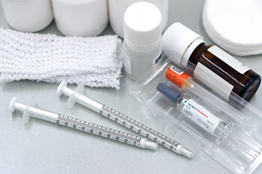 hospital pharmacy shelf with intravenous medication vials, no people, clinical setting
