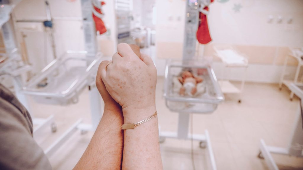 Empty modern hospital maternity ward corridor with incubators, no people
